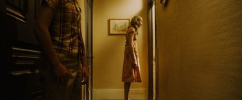 Movie still from “Insidious: The Last Key” (2018), directed by Adam Robitel – A man and a woman standing in front of a door; Medium shot, Low angle
