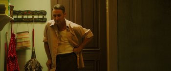 Movie still from “Insidious: The Last Key” (2018), directed by Adam Robitel – A man leaning against a wall with his hands on his hips; Medium shot, Low angle