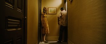 Movie still from “Insidious: The Last Key” (2018), directed by Adam Robitel – A man and a woman standing in a doorway; Wide shot, Low angle