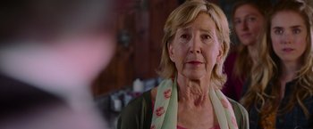 Movie still from “Insidious: The Last Key” (2018), directed by Adam Robitel – An older woman wearing a green and white scarf; Close Up shot, Over the shoulder angle