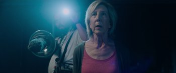 Movie still from “Insidious: The Last Key” (2018), directed by Adam Robitel – An older woman standing in front of a camera; Close Up shot, Low angle