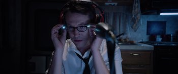 Movie still from “Insidious: The Last Key” (2018), directed by Adam Robitel – A man wearing headphones and a white dress shirt; Close Up shot, High angle