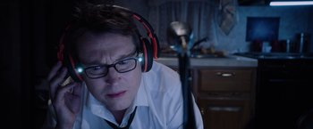 Movie still from “Insidious: The Last Key” (2018), directed by Adam Robitel – A man wearing headphones and a white dress shirt; Close Up shot, Over the shoulder angle