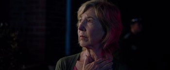 Movie still from “Insidious: The Last Key” (2018), directed by Adam Robitel – An older woman with her hands on her neck; Close Up shot, Low angle