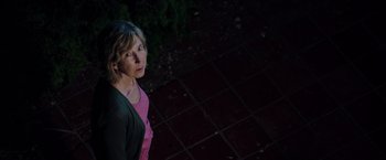 Movie still from “Insidious: The Last Key” (2018), directed by Adam Robitel – An older woman standing on a tiled floor at night; Close Up shot, High angle