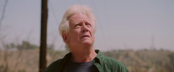 Movie still from “Insidious: The Last Key” (2018), directed by Adam Robitel – An older man with white hair looks upward; Close Up shot, Low angle