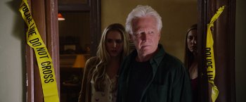 Movie still from “Insidious: The Last Key” (2018), directed by Adam Robitel – An older man standing next to a young woman; Close Up shot, Low angle