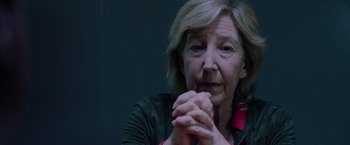 Movie still from “Insidious: The Last Key” (2018), directed by Adam Robitel – An older woman is holding her hands in front of her face; Close Up shot, Over the shoulder angle