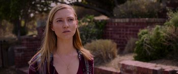 Movie still from “Insidious: The Last Key” (2018), directed by Adam Robitel – A woman standing in front of a brick wall; Close Up shot, Over the shoulder angle