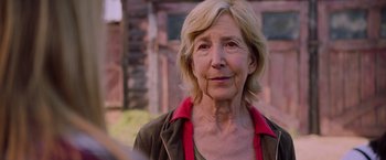 Movie still from “Insidious: The Last Key” (2018), directed by Adam Robitel – An older woman with blonde hair wearing a green shirt; Close Up shot, Over the shoulder angle