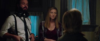 Movie still from “Insidious: The Last Key” (2018), directed by Adam Robitel – A woman sitting in front of two other women; Medium shot, Over the shoulder angle