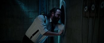 Movie still from “Insidious: The Last Key” (2018), directed by Adam Robitel – A man in a suit and tie touching a wall with his hands; Close Up shot, High angle