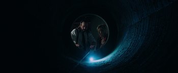 Movie still from “Insidious: The Last Key” (2018), directed by Adam Robitel – A man and a woman looking into a hole; Medium shot, Overhead angle