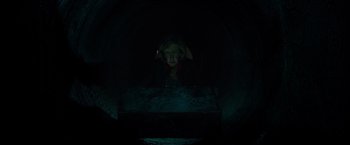 Movie still from “Insidious: The Last Key” (2018), directed by Adam Robitel – A woman is standing in a dark tunnel; Medium shot, Low angle