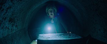 Movie still from “Insidious: The Last Key” (2018), directed by Adam Robitel – An older woman looking into a tunnel with a flashlight; Medium shot, Low angle
