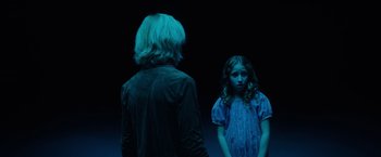 Movie still from “Insidious: The Last Key” (2018), directed by Adam Robitel – A woman and a girl standing next to each other on a stage; Medium shot, Over the shoulder angle