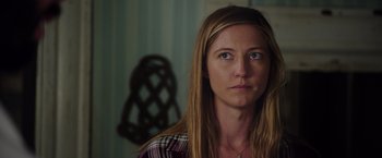 Movie still from “Insidious: The Last Key” (2018), directed by Adam Robitel – A person with long brown hair; Close Up shot, Over the shoulder angle