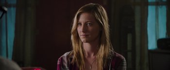 Movie still from “Insidious: The Last Key” (2018), directed by Adam Robitel – A woman with long blonde hair wearing a plaid shirt; Close Up shot, Over the shoulder angle