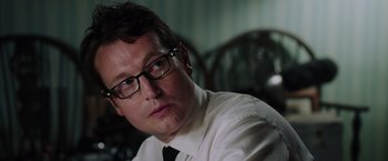 Movie still from “Insidious: The Last Key” (2018), directed by Adam Robitel – A person wearing a shirt and tie; Close Up shot, Over the shoulder angle