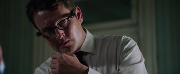 Movie still from “Insidious: The Last Key” (2018), directed by Adam Robitel – A person wearing glasses and adjusting a tie; Close Up shot, Low angle