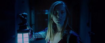 Movie still from “Insidious: The Last Key” (2018), directed by Adam Robitel – A woman with long blonde hair wearing a plaid shirt; Close Up shot, Low angle