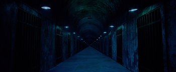 Movie still from “Insidious: The Last Key” (2018), directed by Adam Robitel – A long dark hallway with lights on either side of it; Extreme Wide shot, High angle