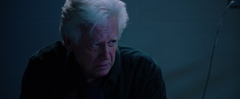Movie still from “Insidious: The Last Key” (2018), directed by Adam Robitel – An older man with white hair looking at the camera; Close Up shot, Over the shoulder angle