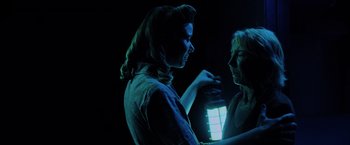 Movie still from “Insidious: The Last Key” (2018), directed by Adam Robitel – A woman holding a flashlight and another woman standing next to her; Medium shot, Over the shoulder angle
