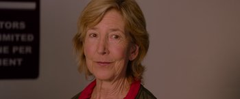 Movie still from “Insidious: The Last Key” (2018), directed by Adam Robitel – An older woman is smiling for the camera; Close Up shot, Low angle