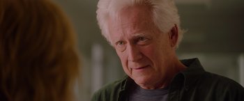 Movie still from “Insidious: The Last Key” (2018), directed by Adam Robitel – An older man with white hair looking at the camera; Close Up shot, Over the shoulder angle