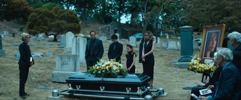 Movie still from “Insidious: The Red Door” (2023), directed by Patrick Wilson – A group of people standing next to an open casket; Wide shot, High angle