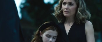 Movie still from “Insidious: The Red Door” (2023), directed by Patrick Wilson – A woman standing next to a young girl in a black dress; Close Up shot, Over the shoulder angle
