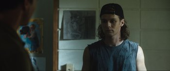 Movie still from “Insidious: The Red Door” (2023), directed by Patrick Wilson – A man with long hair wearing a hat; Medium shot, Over the shoulder angle