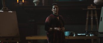 Movie still from “Insidious: The Red Door” (2023), directed by Patrick Wilson – A woman standing in front of a table; Medium shot, Low angle