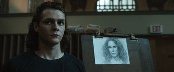 Movie still from “Insidious: The Red Door” (2023), directed by Patrick Wilson – A man standing in front of a drawing of a woman; Close Up shot, Low angle