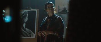 Movie still from “Insidious: The Red Door” (2023), directed by Patrick Wilson – A woman standing in front of an easel in an art studio; Close Up shot, Over the shoulder angle