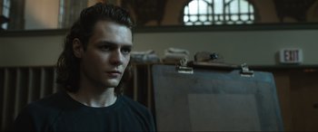 Movie still from “Insidious: The Red Door” (2023), directed by Patrick Wilson – A man standing in front of an easel in a room; Close Up shot, Low angle