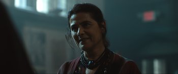 Movie still from “Insidious: The Red Door” (2023), directed by Patrick Wilson – A person wearing a necklace; Close Up shot, Over the shoulder angle