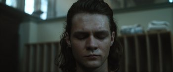 Movie still from “Insidious: The Red Door” (2023), directed by Patrick Wilson – A person with long hair; Close Up shot, Low angle