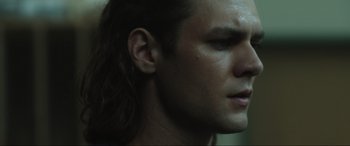 Movie still from “Insidious: The Red Door” (2023), directed by Patrick Wilson – A person with long hair; Close Up shot, Low angle