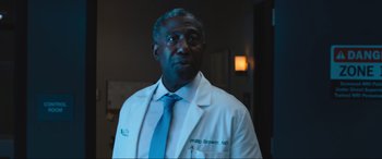 Movie still from “Insidious: The Red Door” (2023), directed by Patrick Wilson – A man in a white lab coat and a blue tie; Close Up shot, Low angle