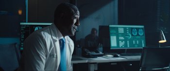 Movie still from “Insidious: The Red Door” (2023), directed by Patrick Wilson – A man sitting in front of a computer monitor; Medium shot, Over the shoulder angle