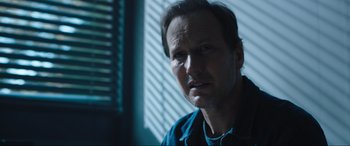 Movie still from “Insidious: The Red Door” (2023), directed by Patrick Wilson – A person wearing a blue shirt; Close Up shot, Over the shoulder angle