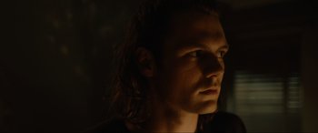 Movie still from “Insidious: The Red Door” (2023), directed by Patrick Wilson – A person with long brown hair; Close Up shot, Low angle