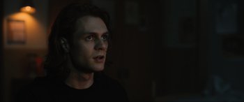 Movie still from “Insidious: The Red Door” (2023), directed by Patrick Wilson – A man with long dark hair is looking into the distance; Close Up shot, Low angle