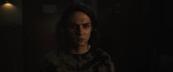 Movie still from “Insidious: The Red Door” (2023), directed by Patrick Wilson – A man with long dark hair is staring straight ahead; Close Up shot, Low angle