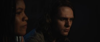 Movie still from “Insidious: The Red Door” (2023), directed by Patrick Wilson – A person with long brown hair; Close Up shot, Over the shoulder angle