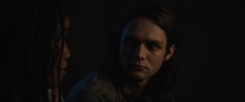 Movie still from “Insidious: The Red Door” (2023), directed by Patrick Wilson – A man with long brown hair stares into the camera; Close Up shot, Low angle