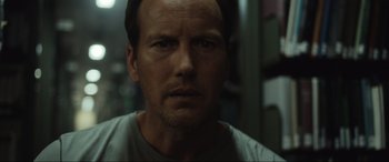 Movie still from “Insidious: The Red Door” (2023), directed by Patrick Wilson – A person wearing a t - shirt; Close Up shot, Low angle