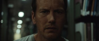 Movie still from “Insidious: The Red Door” (2023), directed by Patrick Wilson – A man's face in a dark room; Close Up shot, Low angle